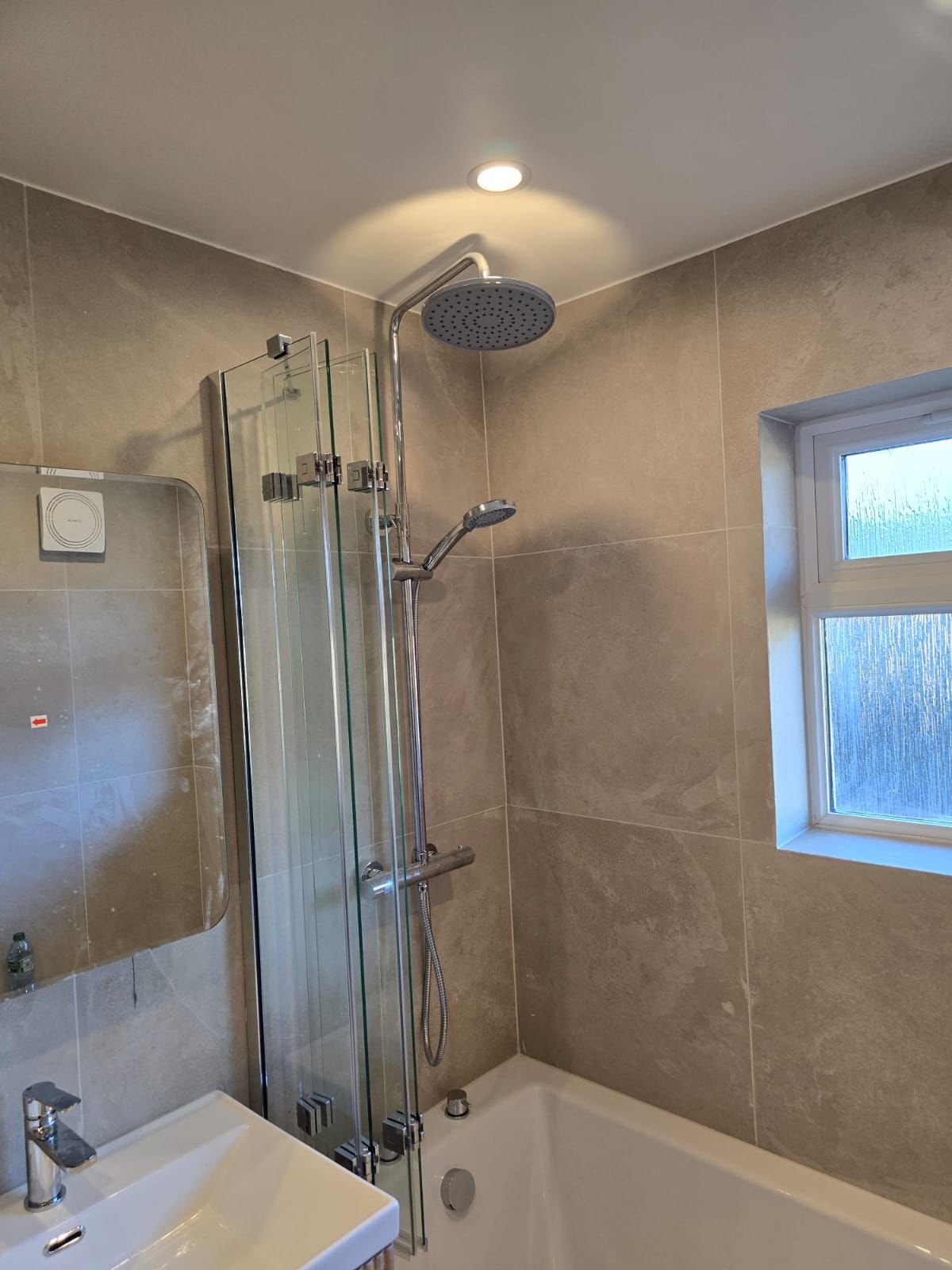 Modern walk-in shower with rainfall showerhead and adjacent vanity sink - bathroom fitting Dunstable